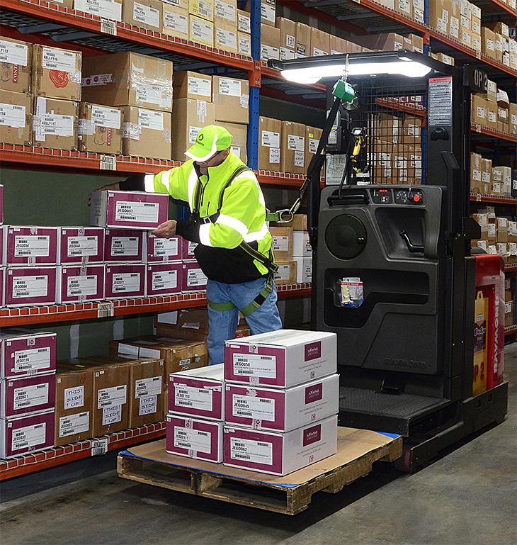 Warehouse worker scanning a box of wine